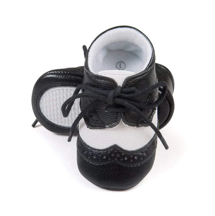 Vintage style baby walking shoes with soft soles and synthetic leather uppers in multiple colours