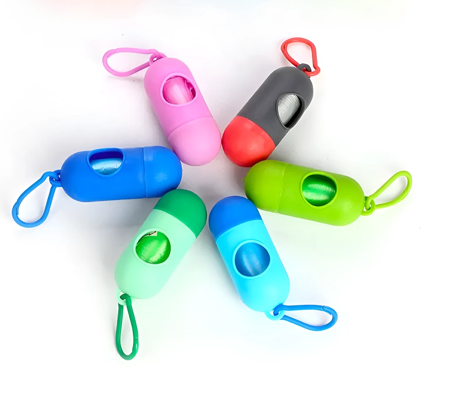 Set of five rolled pet waste bags in assorted colours on a green background.