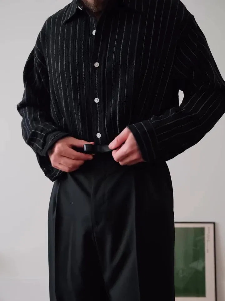 Black pinstriped polyester button-down shirt with regular fit on hanger