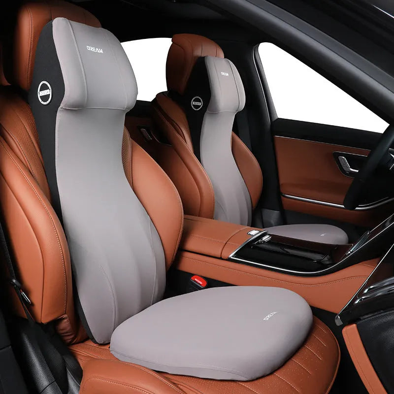 Black automotive memory foam waist cushion and headrest lumbar support pillow on a car seat.