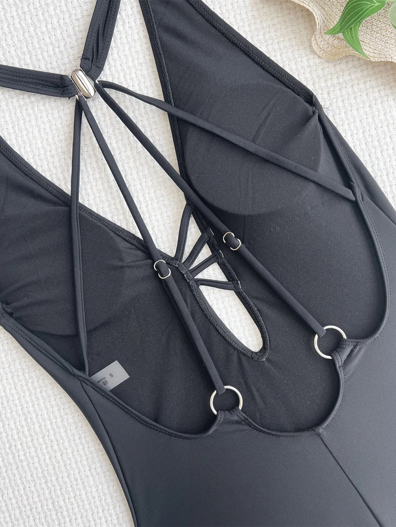 Solid black women's nylon bikini swimsuit laid flat