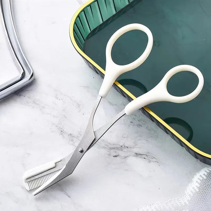 White and pink curved moon-shaped eyebrow trimming knife with a comb on a white background.