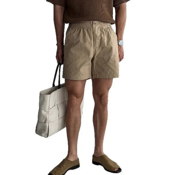 Cotton loose-fit sports shorts in black, shown on a model, suitable for summer activities.