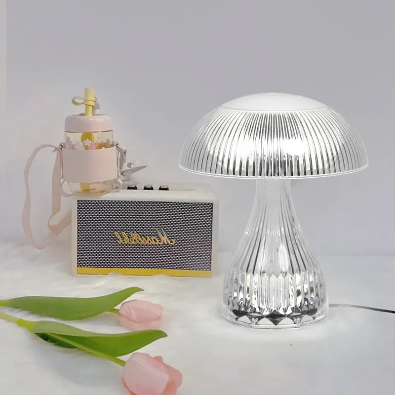 Small white touch-control night lamp with USB charging cable on wooden surface