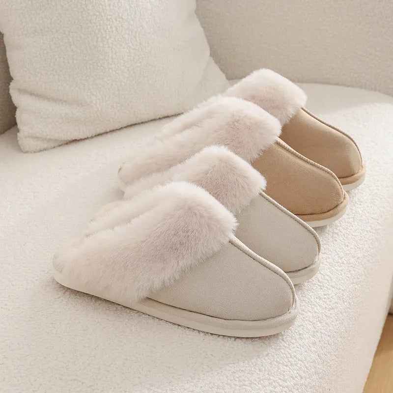 Brown plush indoor slippers with round toe, decorative stitching, and a light-coloured anti-slip sole.