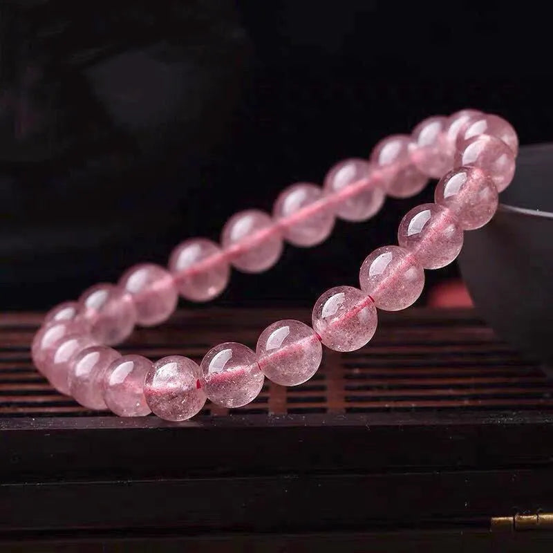 Women's strawberry quartz bracelet with polished beads in 6mm, 8mm, or 10mm sizes.