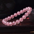 Women's strawberry quartz bracelet with polished beads in 6mm, 8mm, or 10mm sizes.