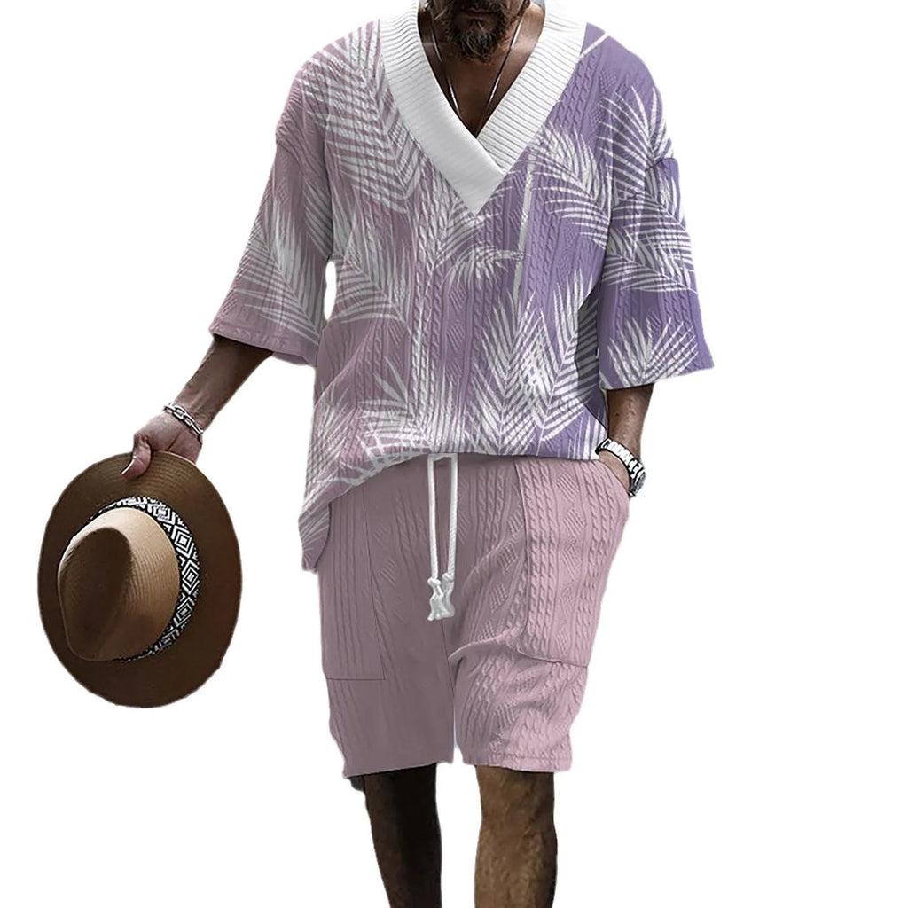 Man wearing a grey printed knitted short-sleeved top with drop shoulders and matching shorts, a casual two-piece suit set.