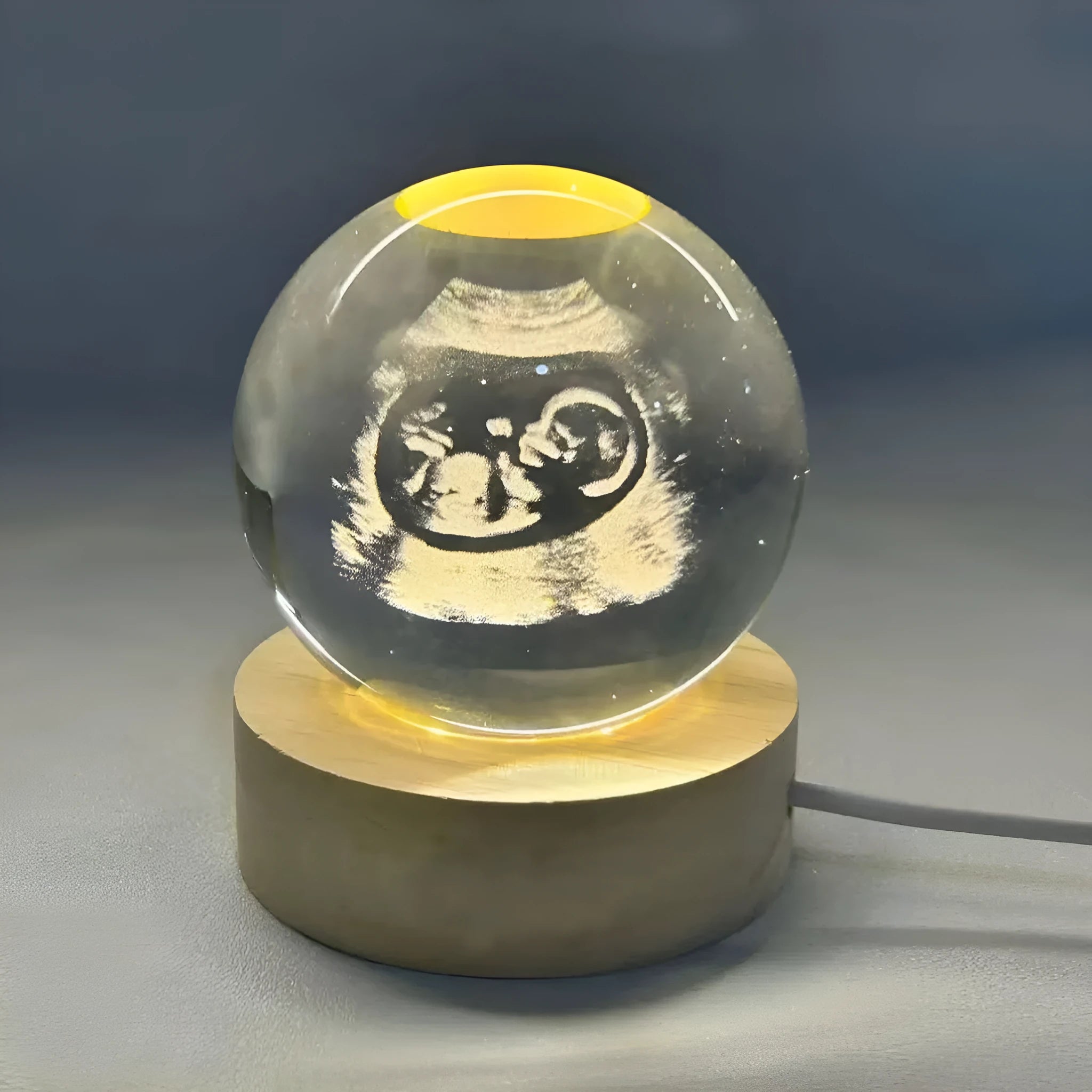 Clear crystal ball night lamp with warm light placed on base, 6cm or 8cm size option available