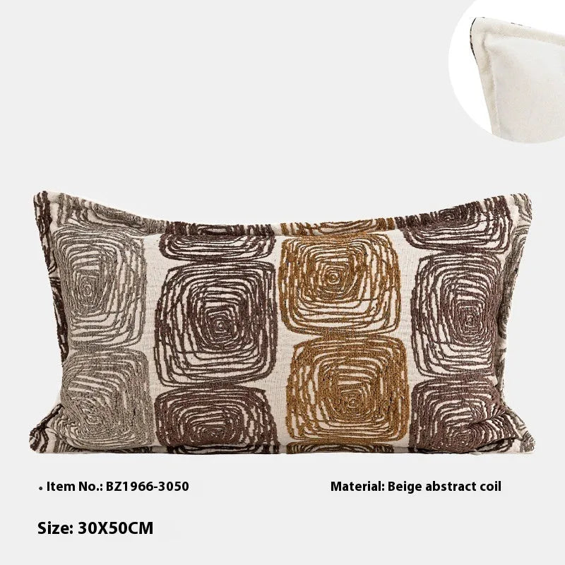 Cream and coffee-coloured abstract coil pattern on two pillow covers: one square, one rectangular.