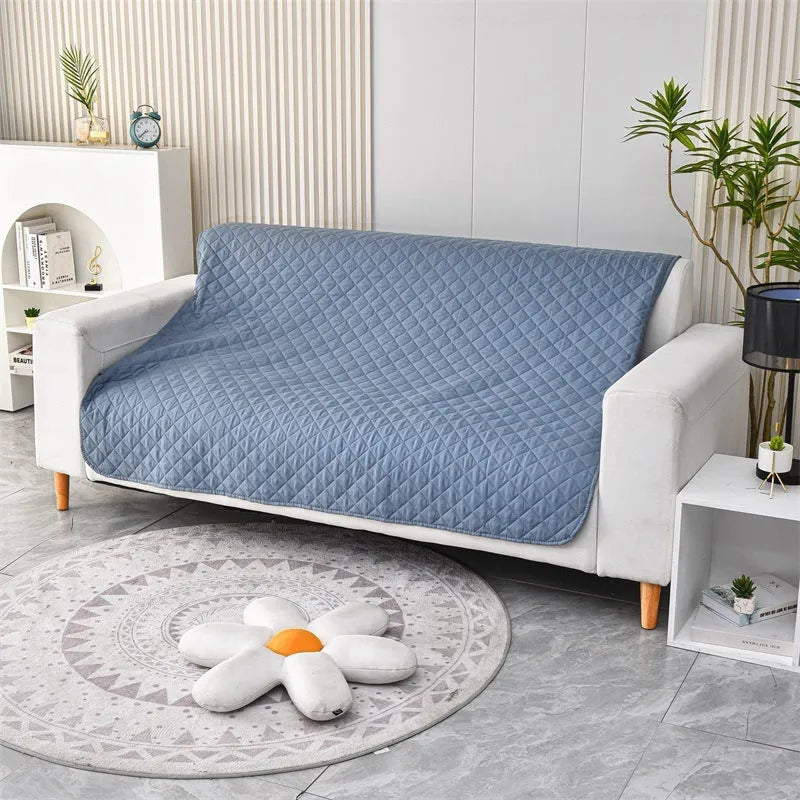 Reversible dog blanket couch cover in grey, laid flat on a sofa