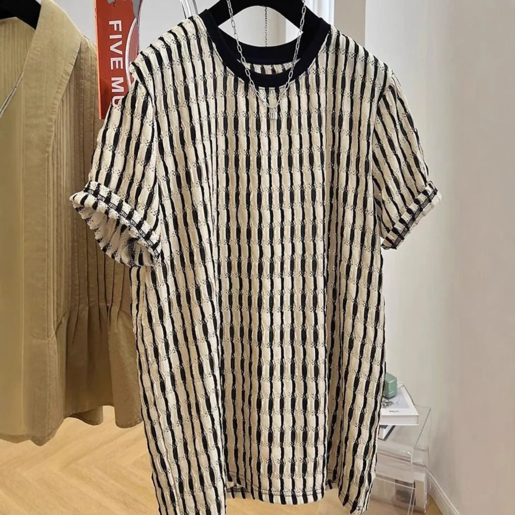 Black and white striped men's short sleeve loose fit pullover shirt on a hanger.