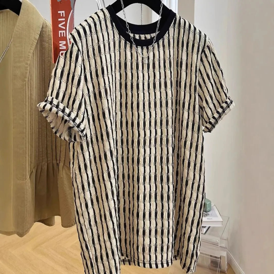 Black and white striped men's short sleeve loose fit pullover shirt on a hanger.