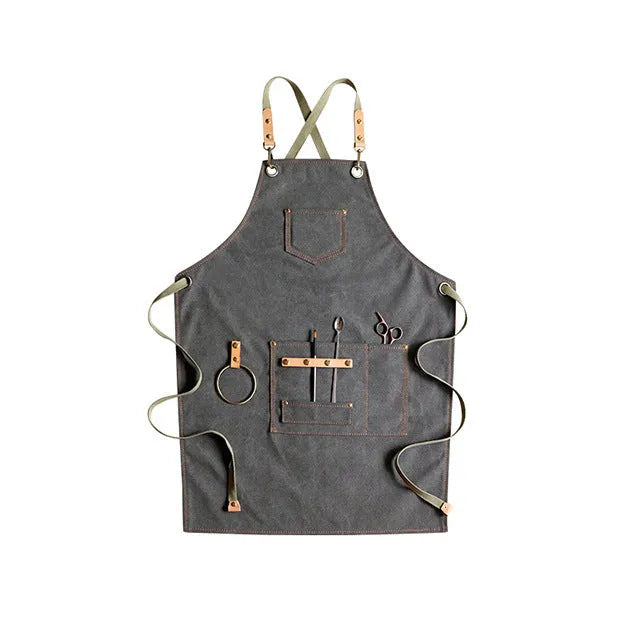 Canvas apron with cross-back straps in camel colour, shown laid flat