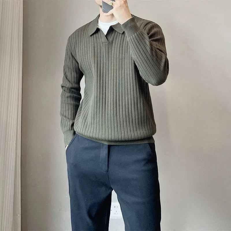 Man wearing a loose black textured knit pullover sweater with long sleeves.