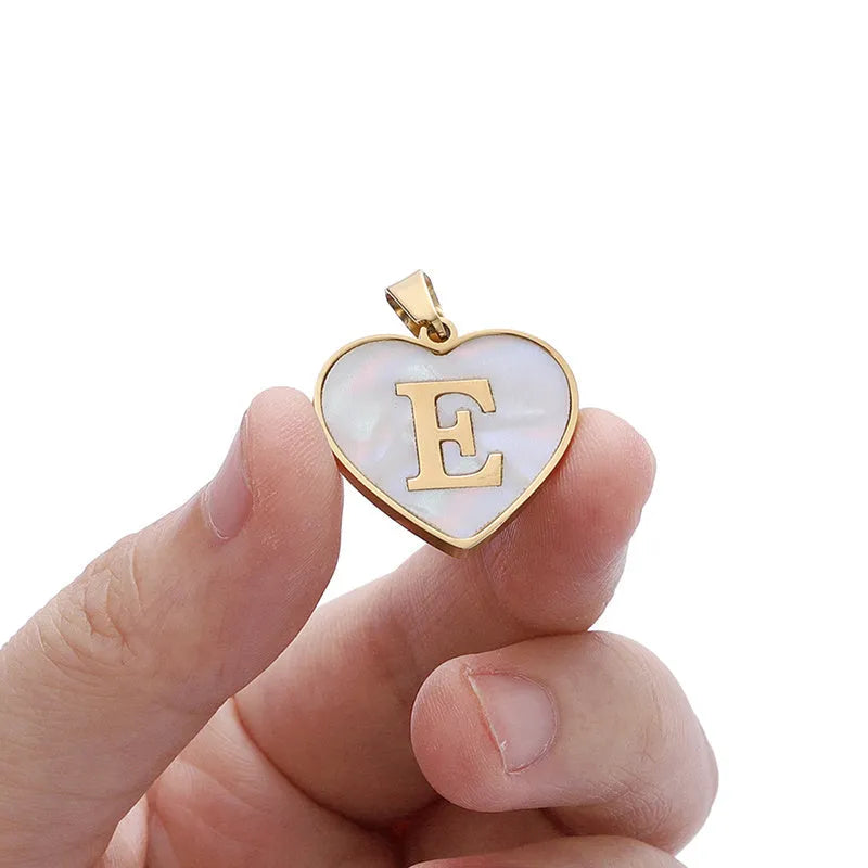 Gold heart necklace with white shell pendant and initial charm on 45cm adjustable chain