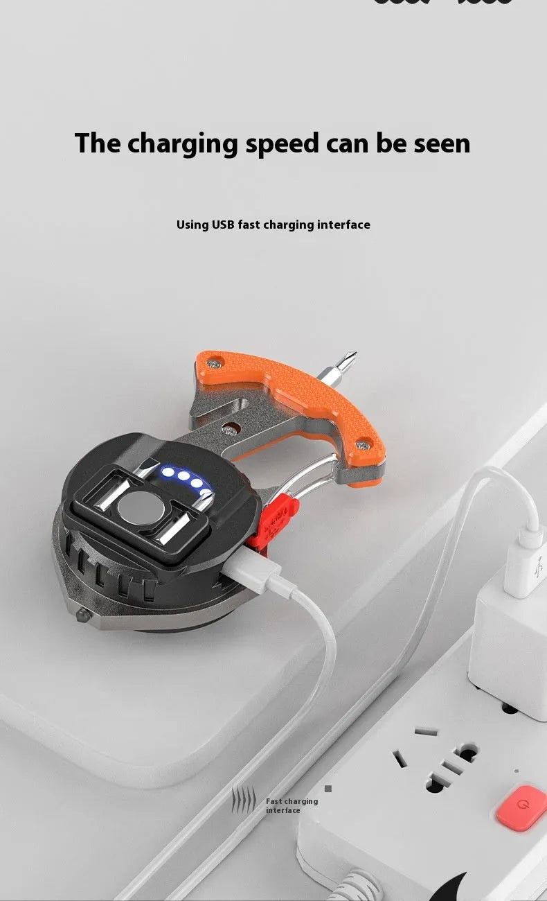 Compact silver and black keychain flashlight with multiple LEDs, a keyring loop, and a pointed window-breaking tip.
