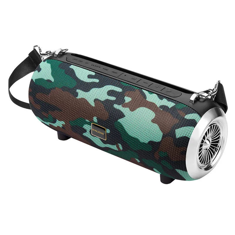 F666 Mini portable Bluetooth speaker with fabric mesh finish, shoulder strap, and standing next to a mobile phone.