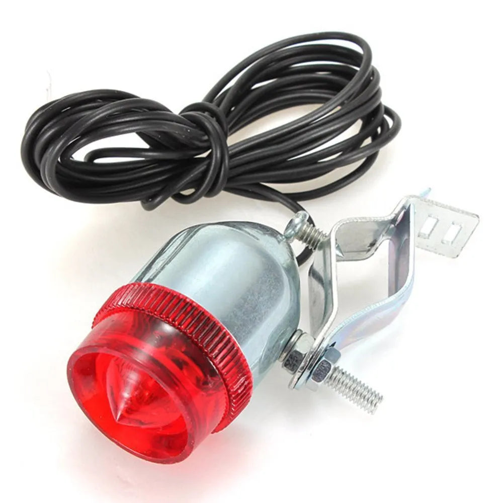 Silver aluminium bicycle dynamo light kit mounted on a bike fork for friction-powered lighting.