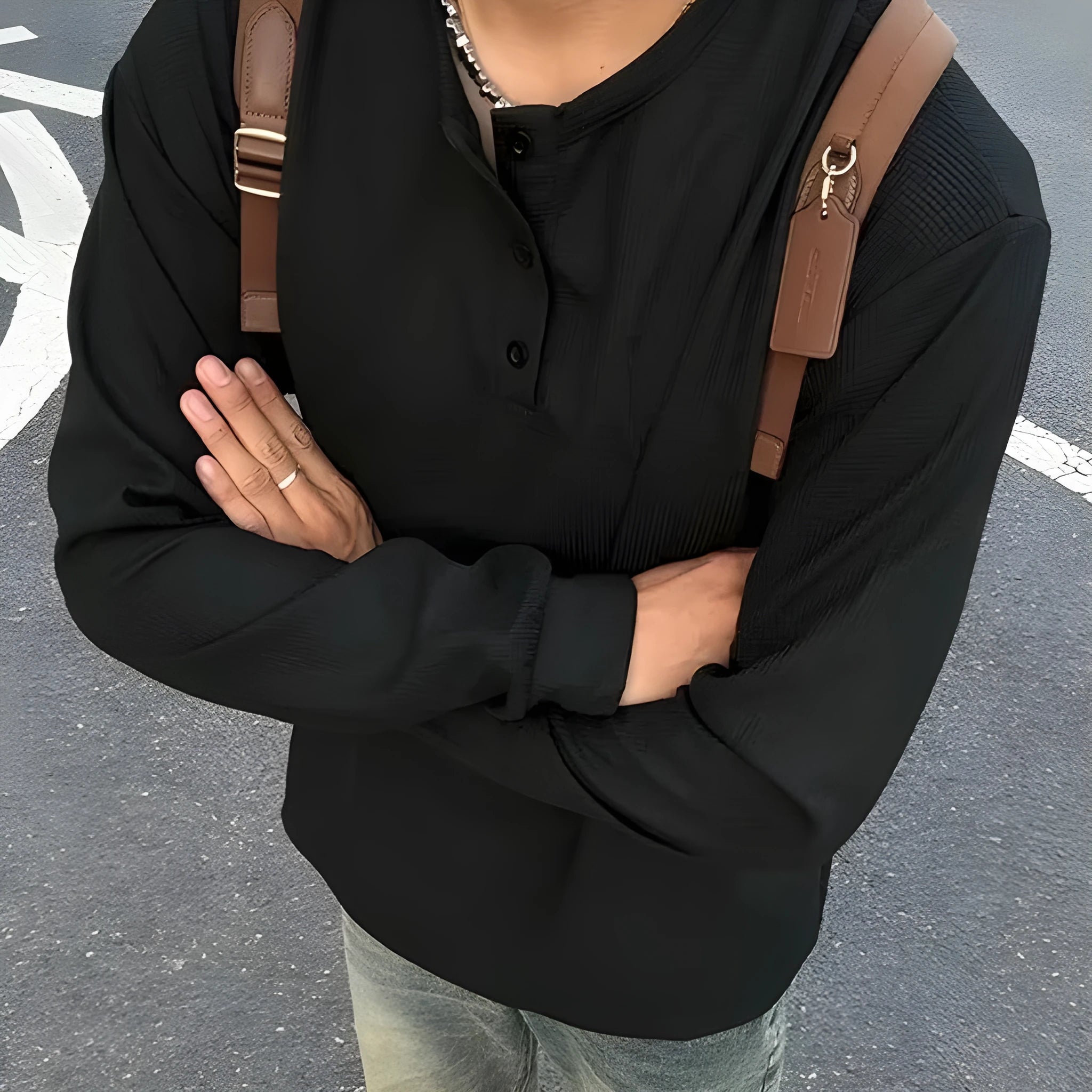 Men's black long-sleeved pullover top with Henry collar in loose fit for daily wear