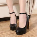 Women's chunky heel high heels in black and white with round toe and rubber sole.