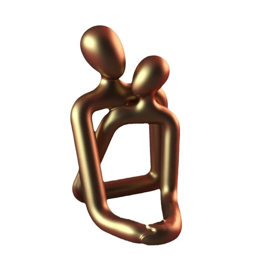 Modern couple resin statue in milky white or gold colour on a desk or shelf