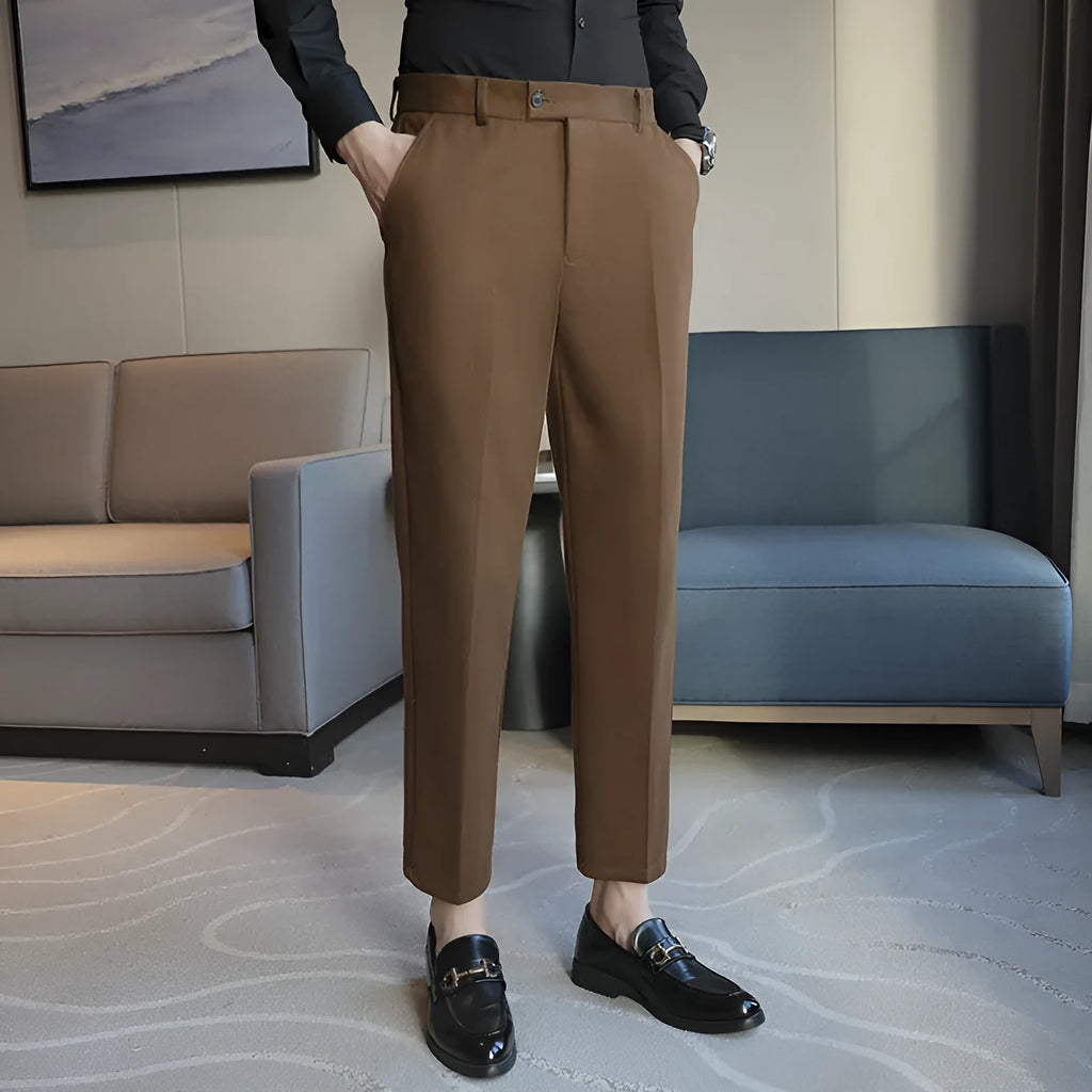 Straight-leg brown corduroy trousers with an elasticated waistband laid flat.