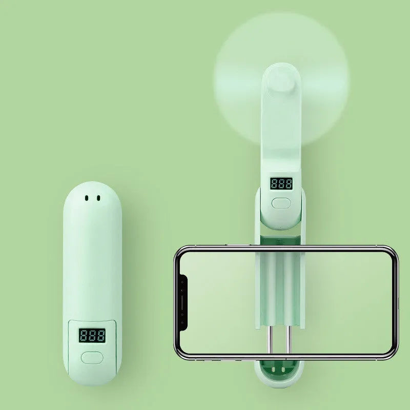 Folding mini personal fan in green colour showing collapsed and open positions with USB charging cable