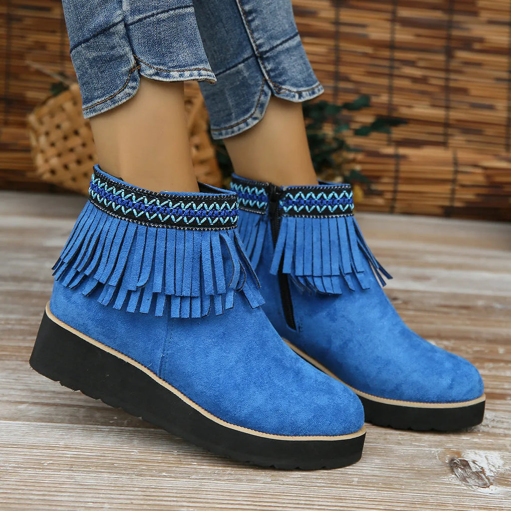 Women's black suede wedge ankle boots with side zipper and decorative tassel on a thick rubber sole.