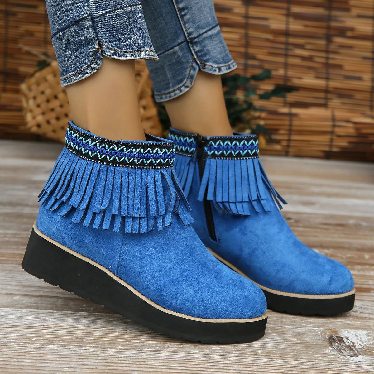 Women's black suede wedge ankle boots with side zipper and decorative tassel on a thick rubber sole.