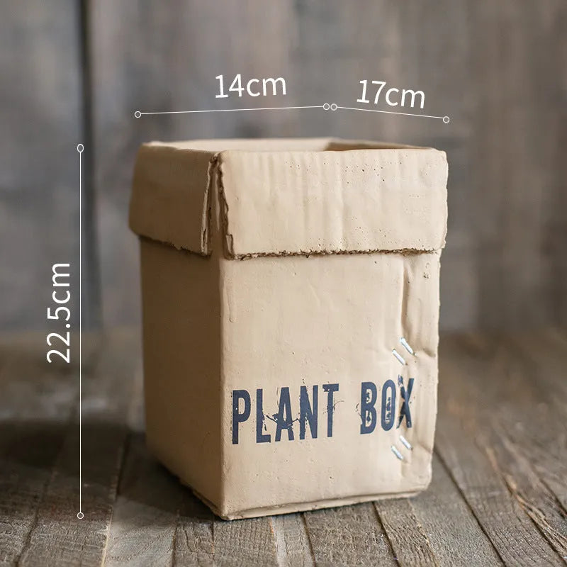 Cement flowerpot with bottom drainage holes and paper box texture in Nordic style design