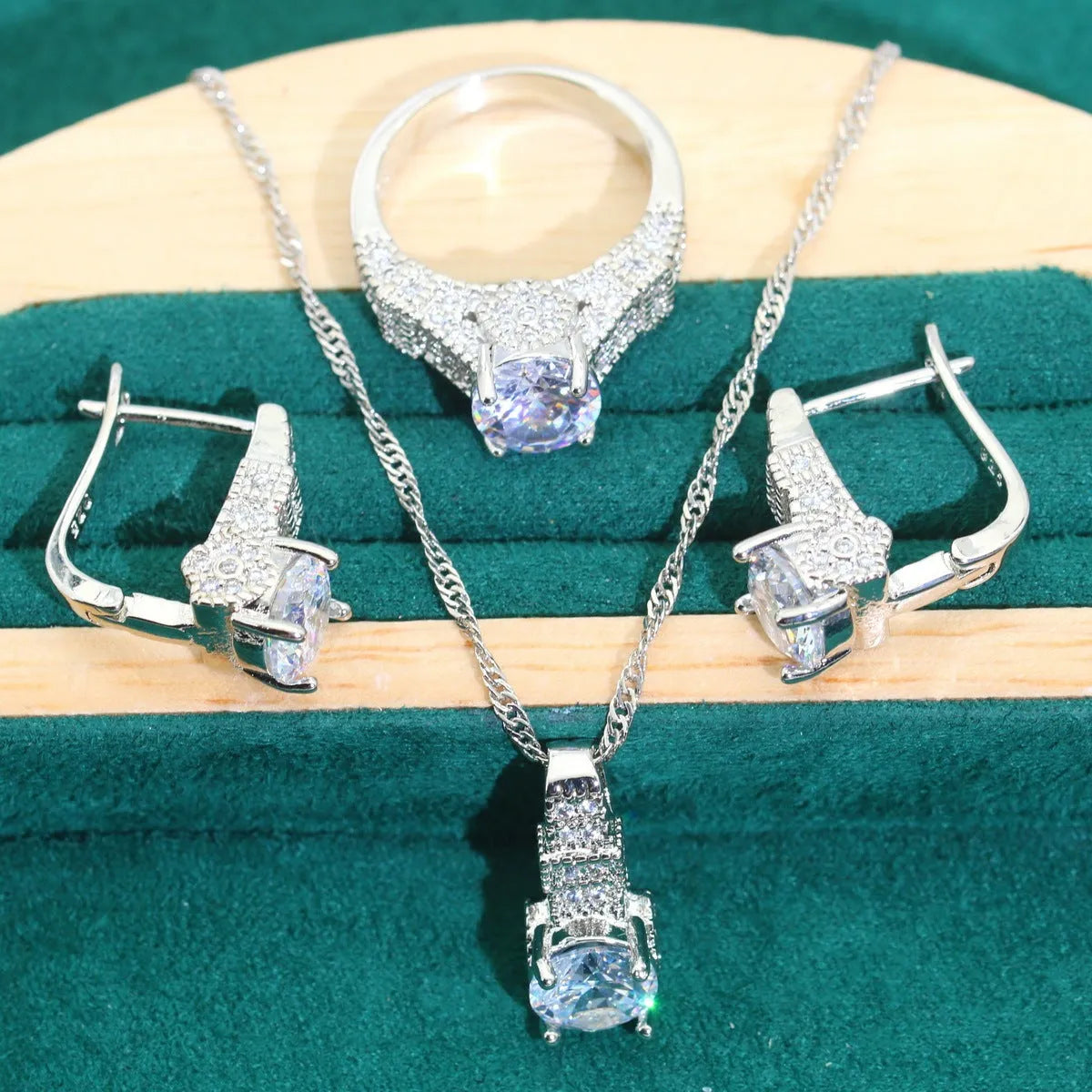 Four-piece bridal jewellery set with water wave chain necklace, bracelet, earrings, and ring in alloy with zircon detailing