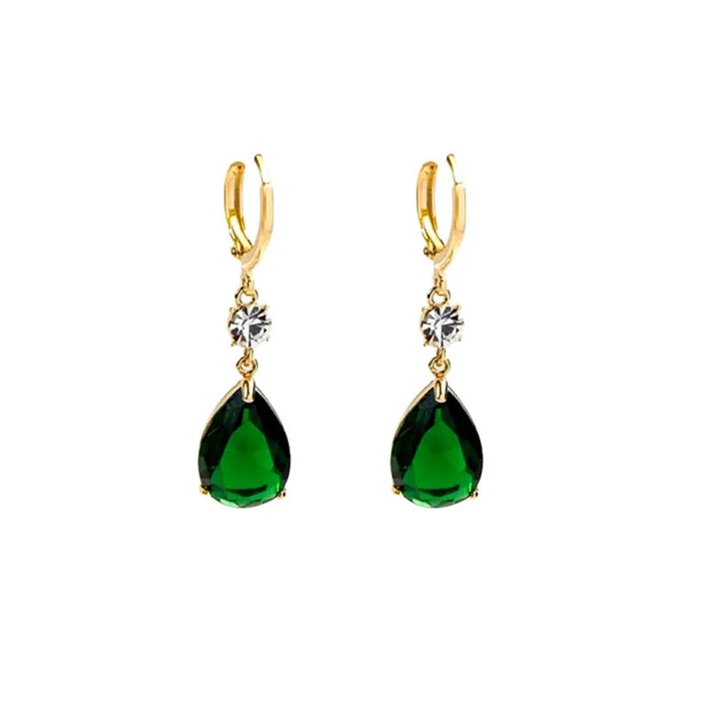 Geometric green teardrop alloy earrings on a plain background