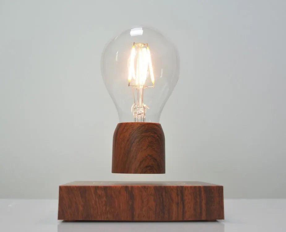 Magnetic levitation light bulb with imitation wood base on table.