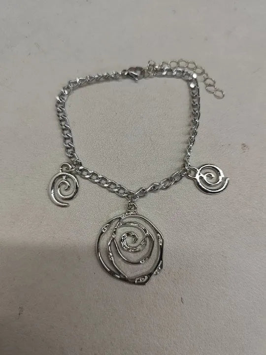 Women's spiral donut jewellery set showing necklace, bracelet and earrings in gold alloy finish