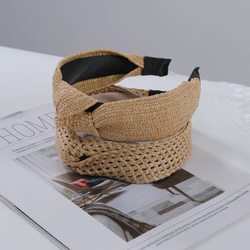 Bamboo woven wide brim hair band in black with bend and hitch details, side view on plain background