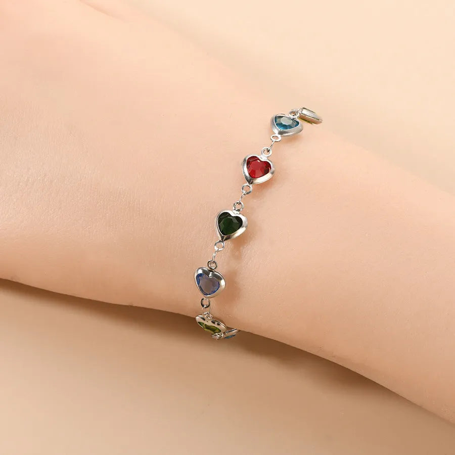 Stainless steel heart-shaped bracelet with electroplated geometric design in various colours like red, blue, and green for unisex wear.