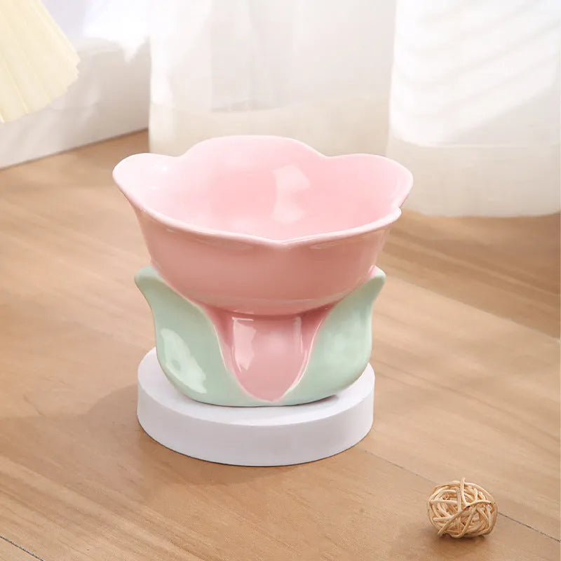 Blue ceramic elevated pet feeding bowl with floral pattern and non-slip base