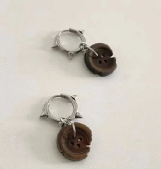 One pair of brown alloy ancient style burned gap button distressed earrings on neutral background