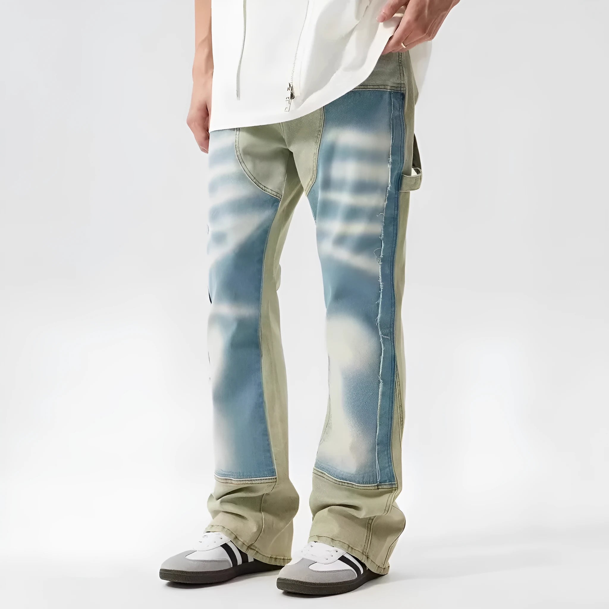 Retro blue and yellow patchwork jeans with splash-ink damaged design on a mid-waist fit.