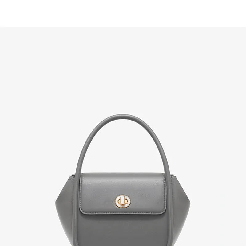 Women's leather wing tote handbag with cross-body strap and hard handle in cow leather