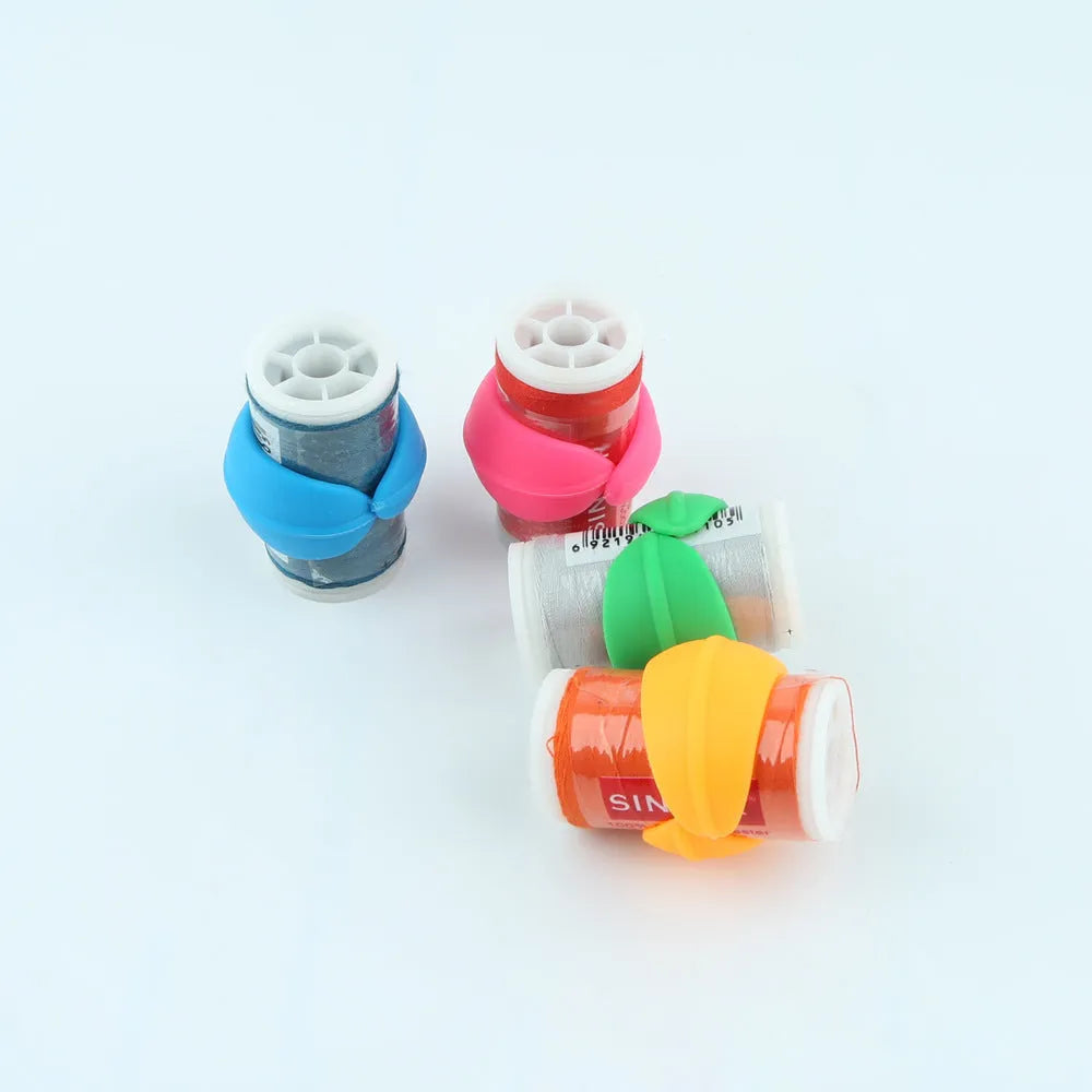 14 silicone sewing spool fixed clips in red, blue, orange, and green on a white background