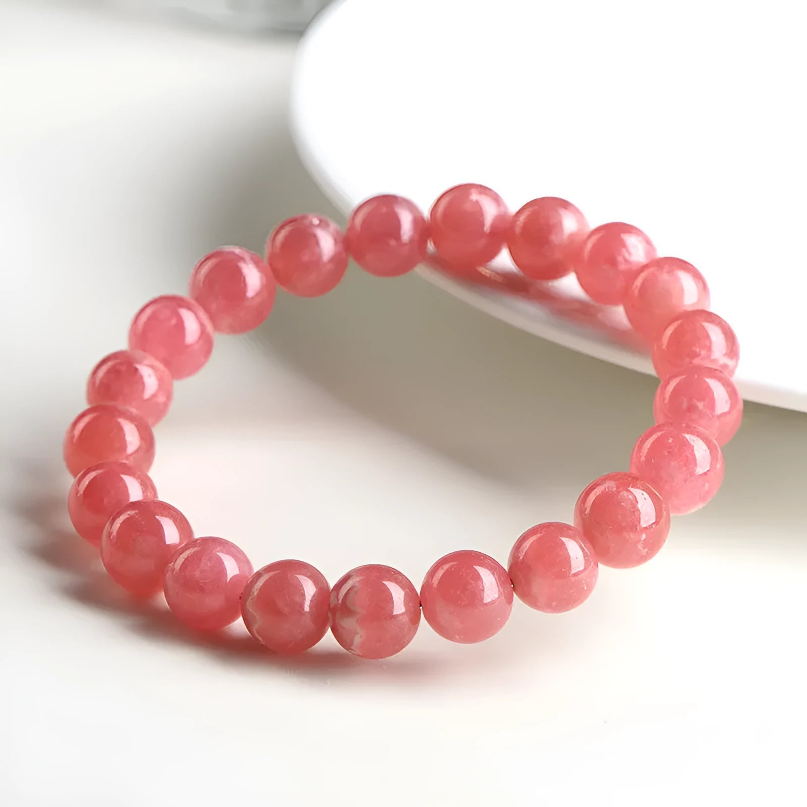 Women's crystal bracelet with red rhodochrosite stones in geometric design featuring longevity lock element