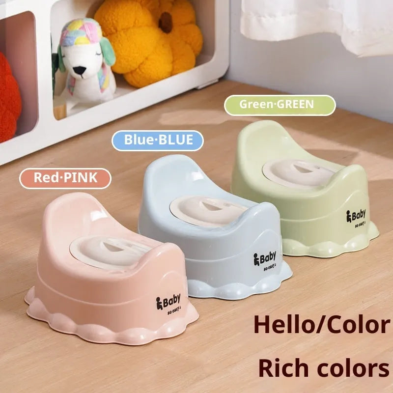 Children's small portable thickened toilet in Green with lid on white background