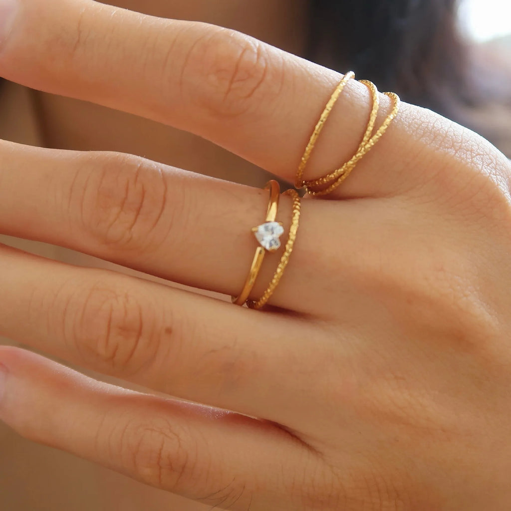 Golden stainless steel ring with either love heart or oval charm on simple band