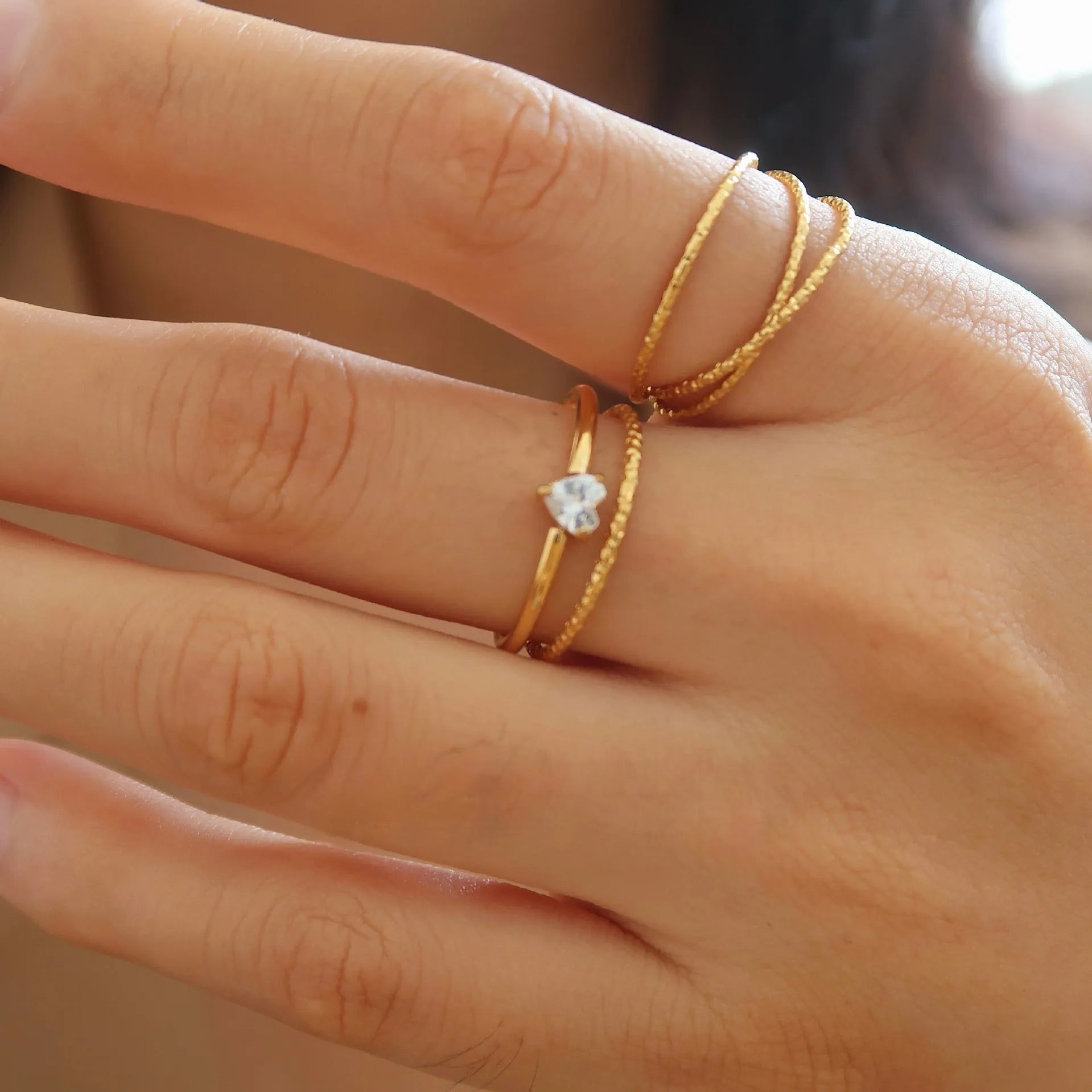 Golden stainless steel ring with either love heart or oval charm on simple band
