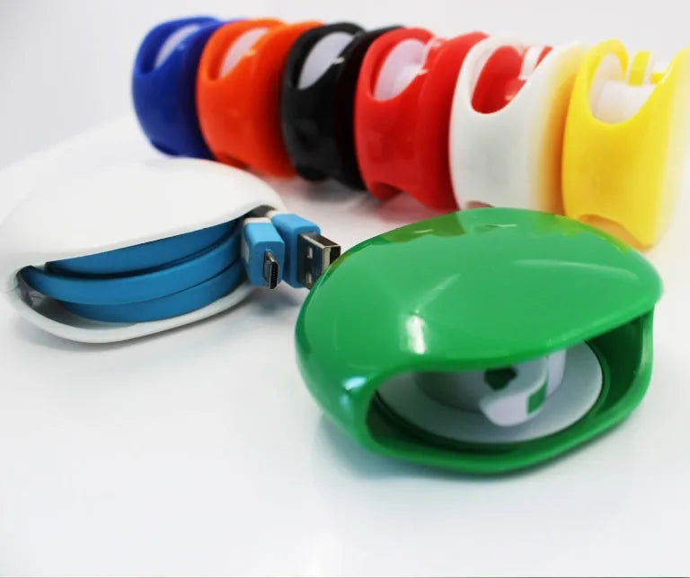 Automatic earphone cable retractor winder in a compact plastic storage box.