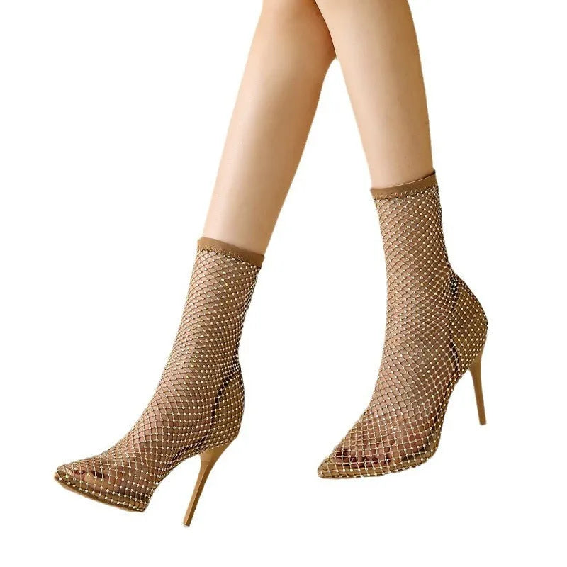 Gold coloured women's stiletto sandals with mesh upper and pointed toe.