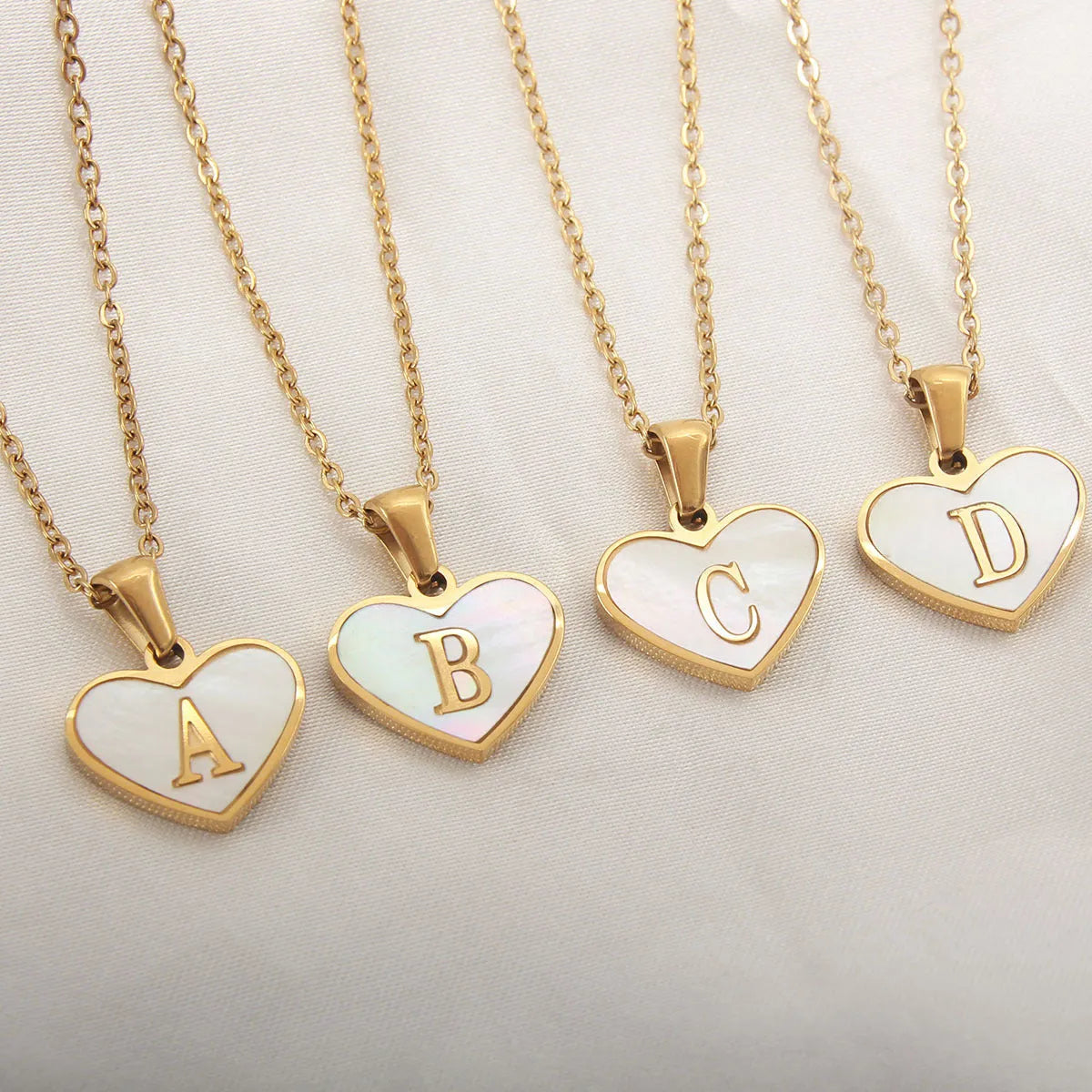 Gold heart necklace with white shell pendant and initial charm on 45cm adjustable chain