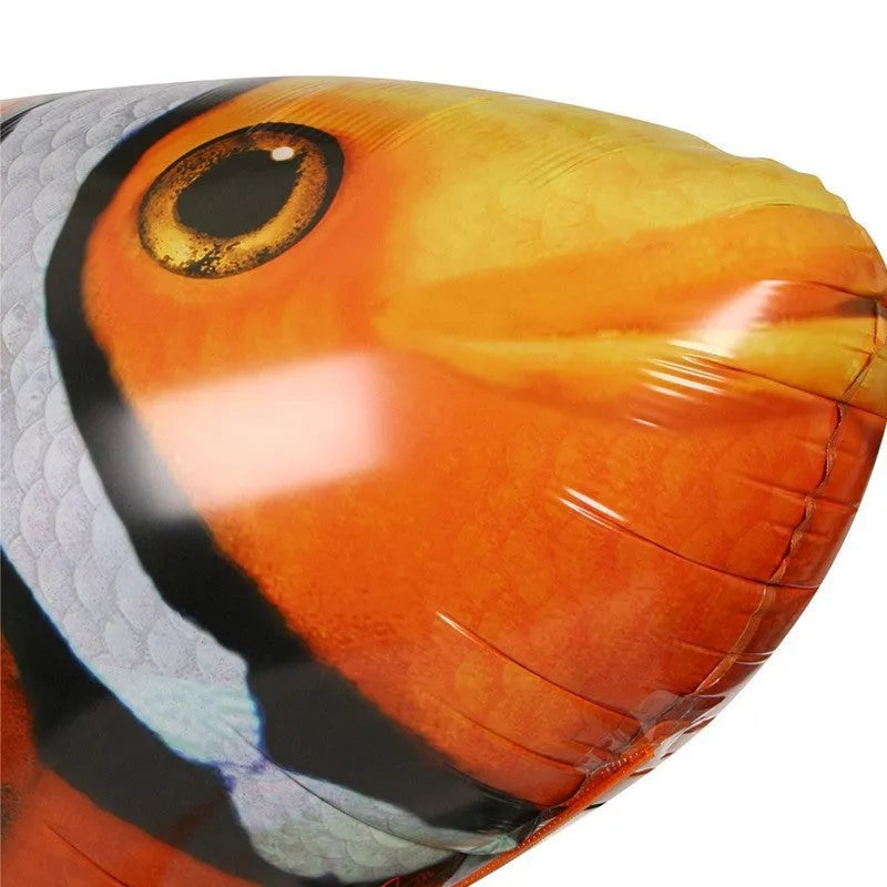Large remote control shark-shaped helium balloon toy floating indoors with a remote.
